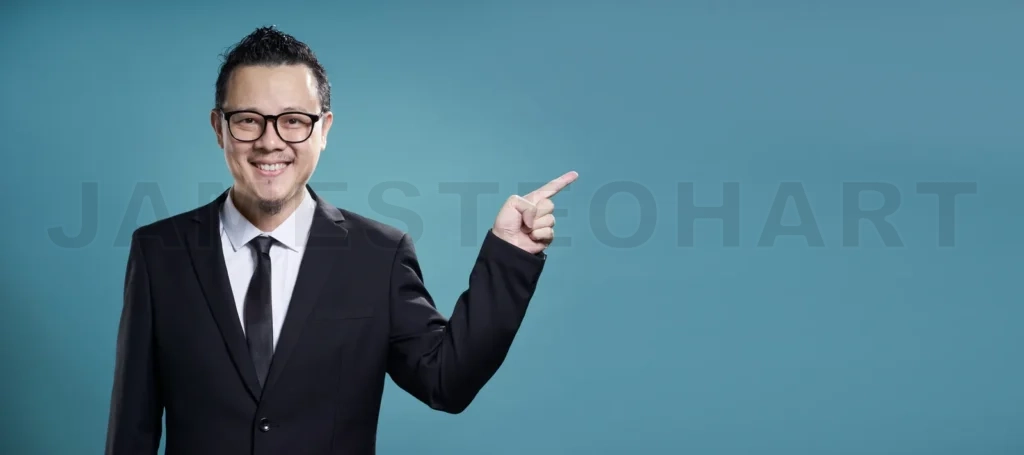 
Businessman in suit smile and finger point to the right