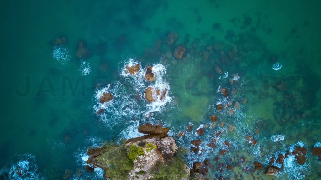 
Aerial view of beach with rocky and waves