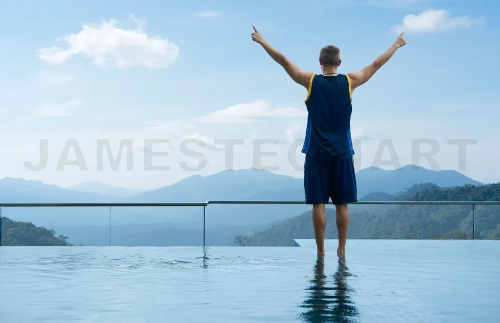 
Young guy stand on swimming pool