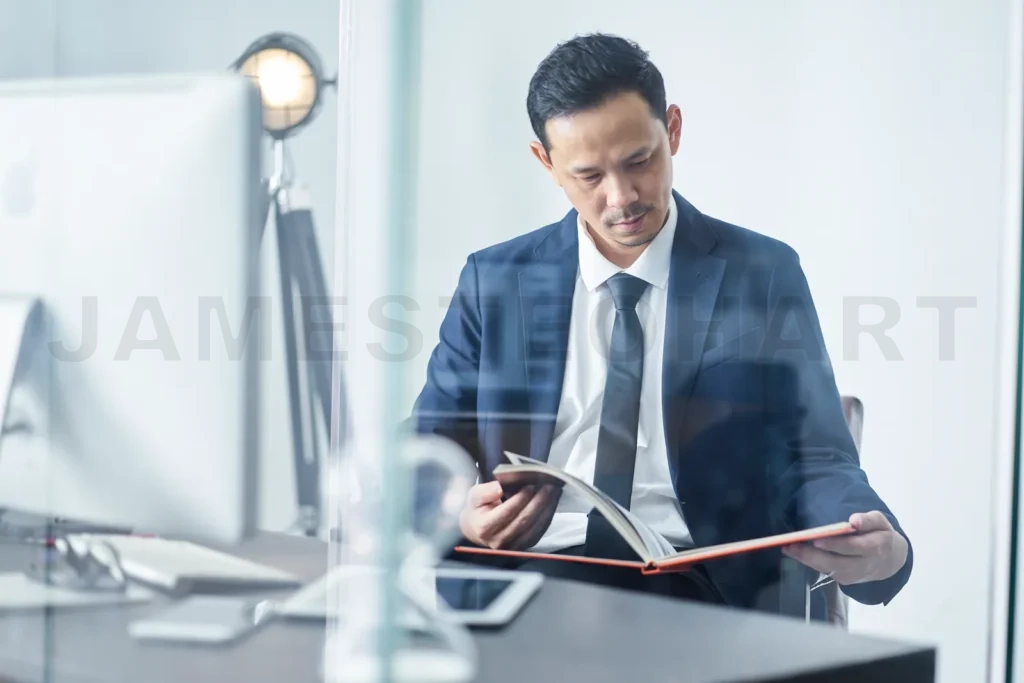 
Businessman reading book in office