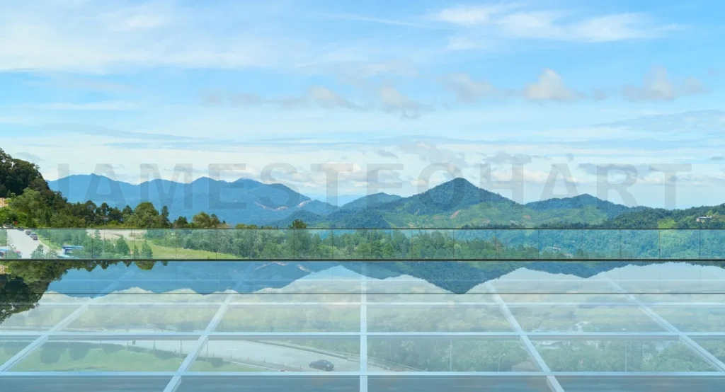 
Empty glass floor platform reflecting majestic mountains and sky
