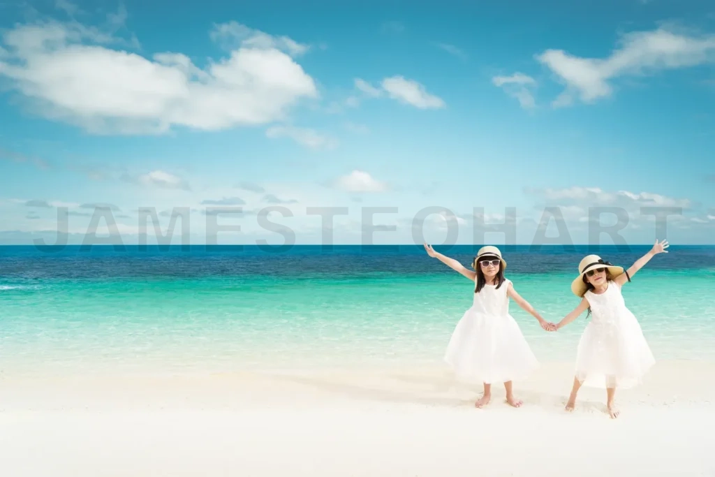 
Portrait Of Happy Asian Sister At Sandy Beach In Summer Vacation