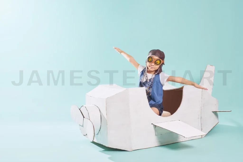 
Little Cute Girl Playing With A Cardboard Airplane