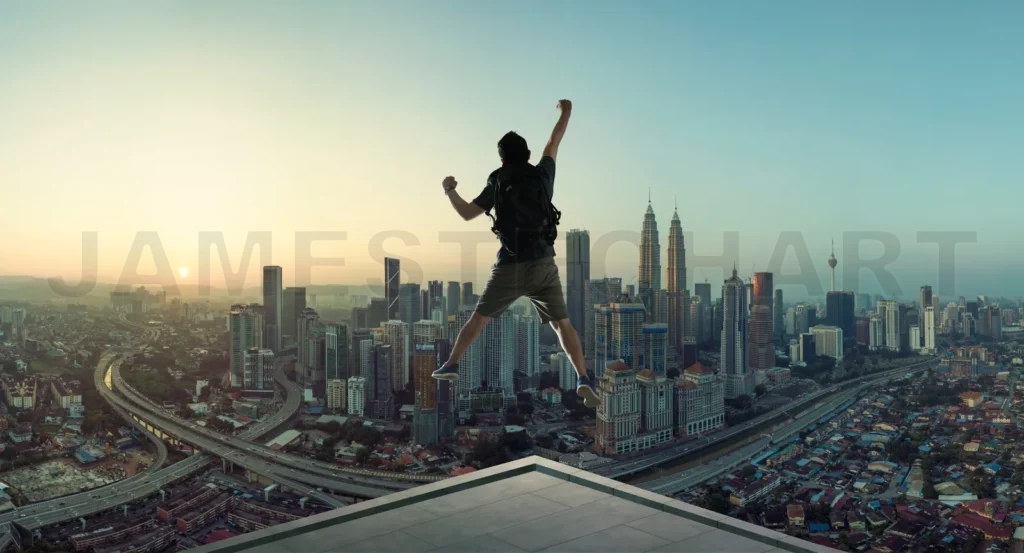 
Young Man Jumping On Rooftop With Great Cityscape Sunrise View