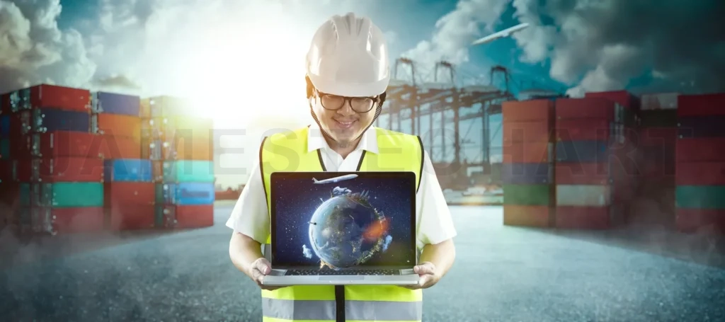 
Logistics worker holding laptop displaying global transport network