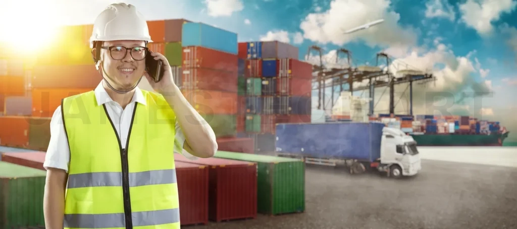 
Asian logistics worker talking on phone at cargo port