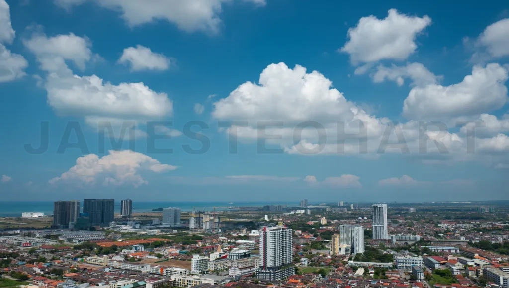 
Modern cityscape expanding near the coast under a cloudy sky