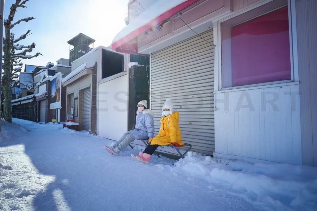 
Two sisters sitting and resting in the streets of Otaru, Hokkaid