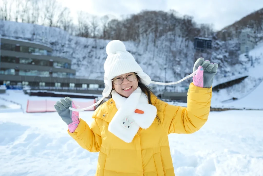 
Beautiful asian little girl smiling happy with travel in snow wi