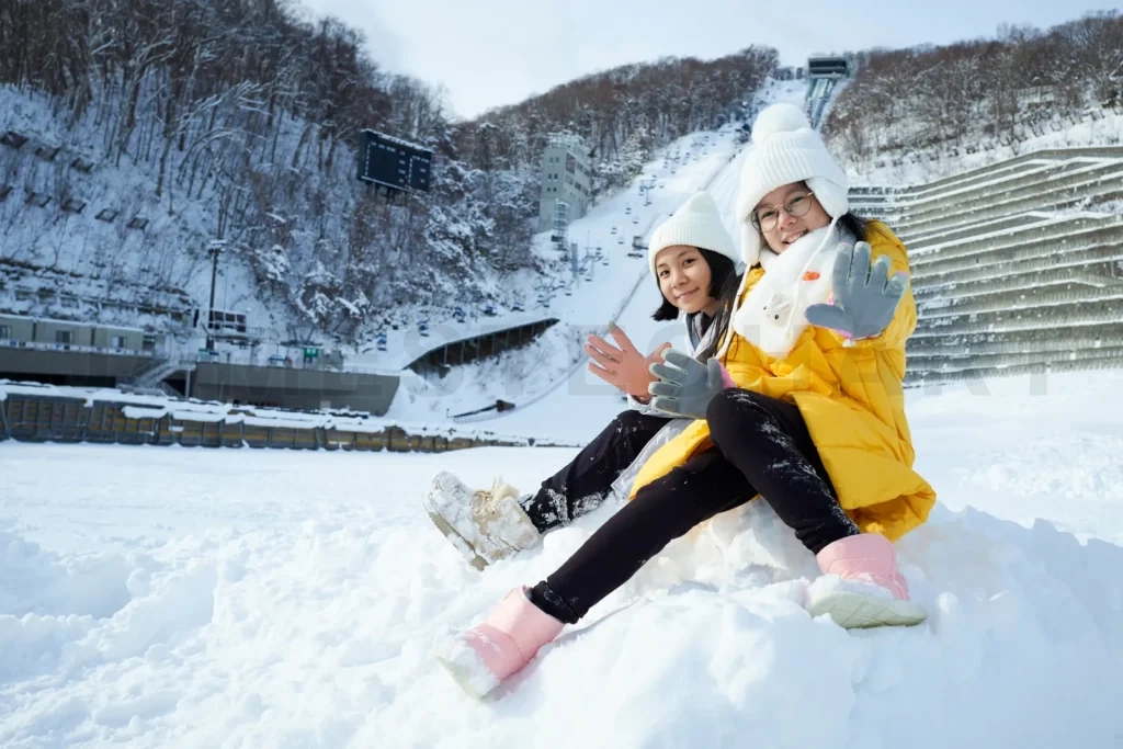 
Beautiful asian two sisters smiling happy with travel in snow wi