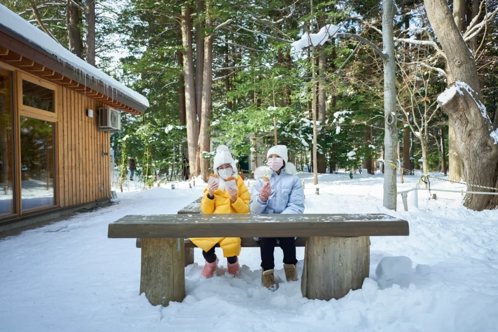 
Beautiful Asian two sisters enjoy Hokkaido food while traveling