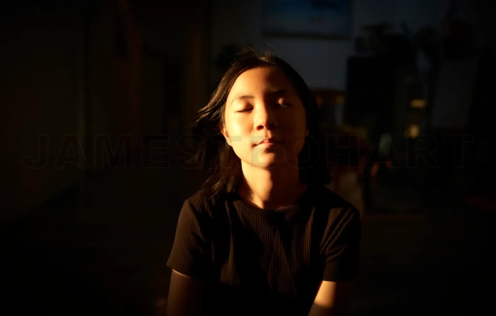 
Asian teen girl leisurely enjoying the sunshine on her face