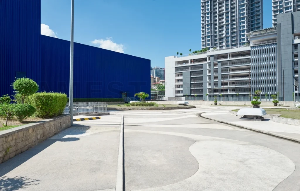 
Empty parking lot surrounded by buildings on sunny summer day