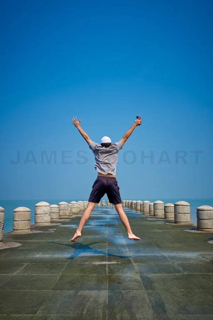 
Tourists jumping happily on the pier
