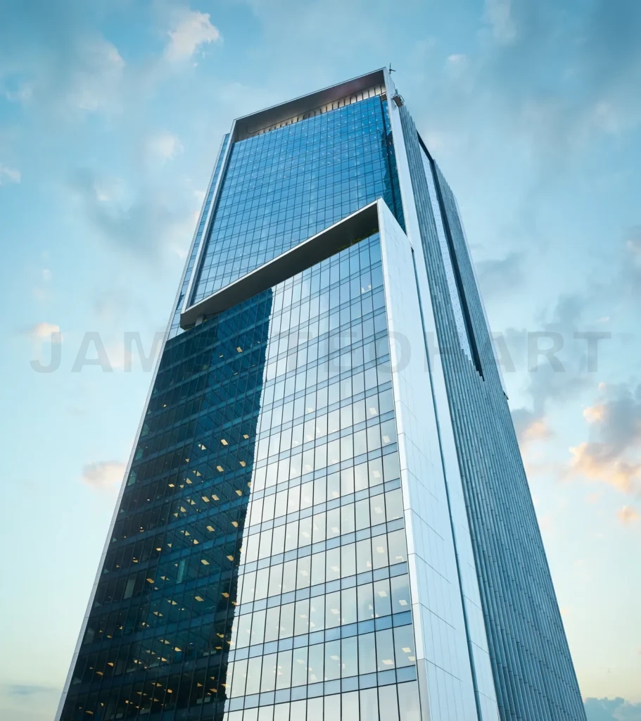 
Modern office building made of glass standing tall against cloud