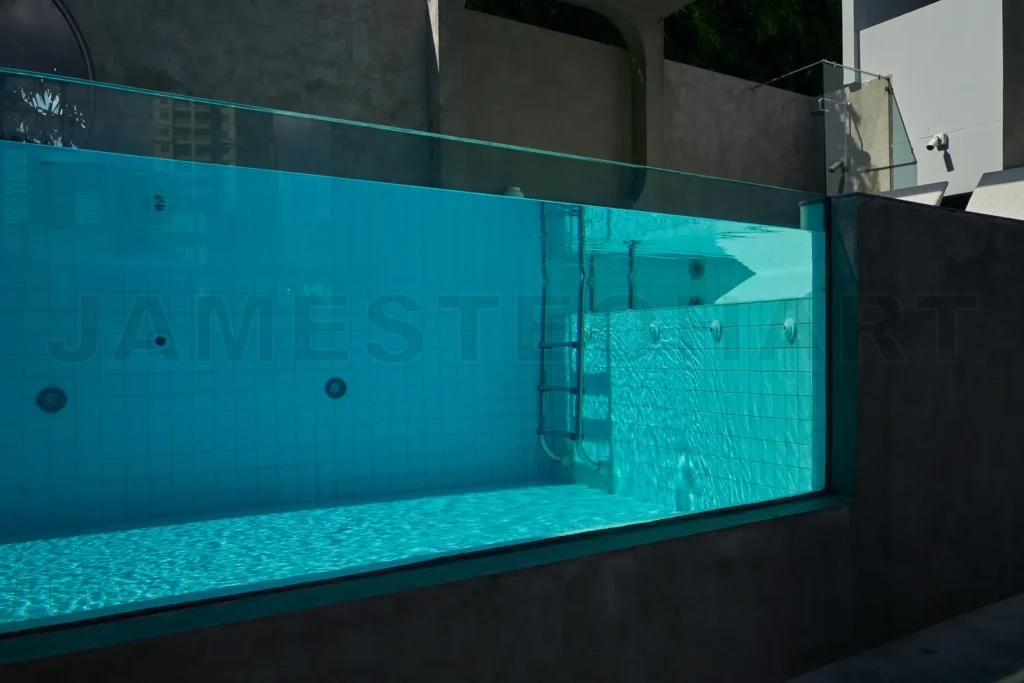 
Mini swimming pool with clear blue water and trasparent glass wa