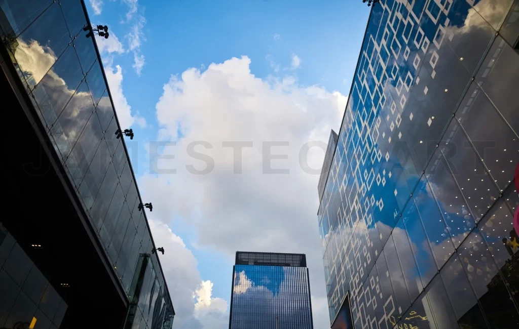 
Modern glass exterior of business office building against sky