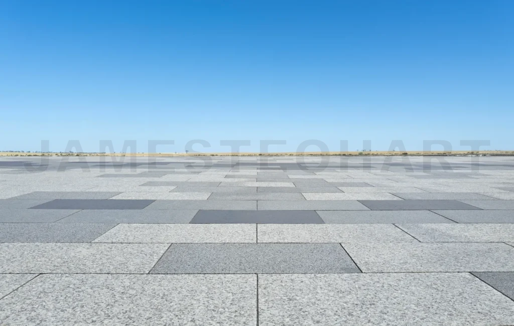 
Empty square made of stone tiles under blue sky