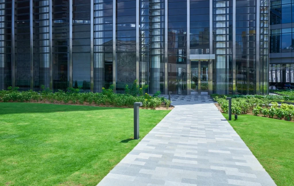 
Stone path leading to modern office building entrance surrounded