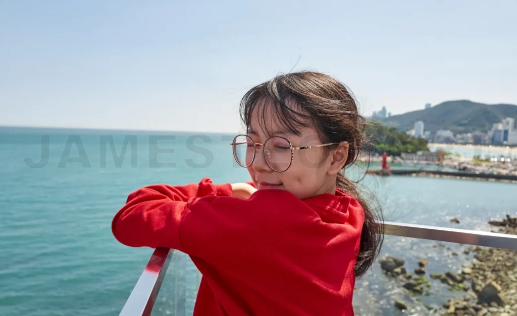 
Young girl enjoying seaside view