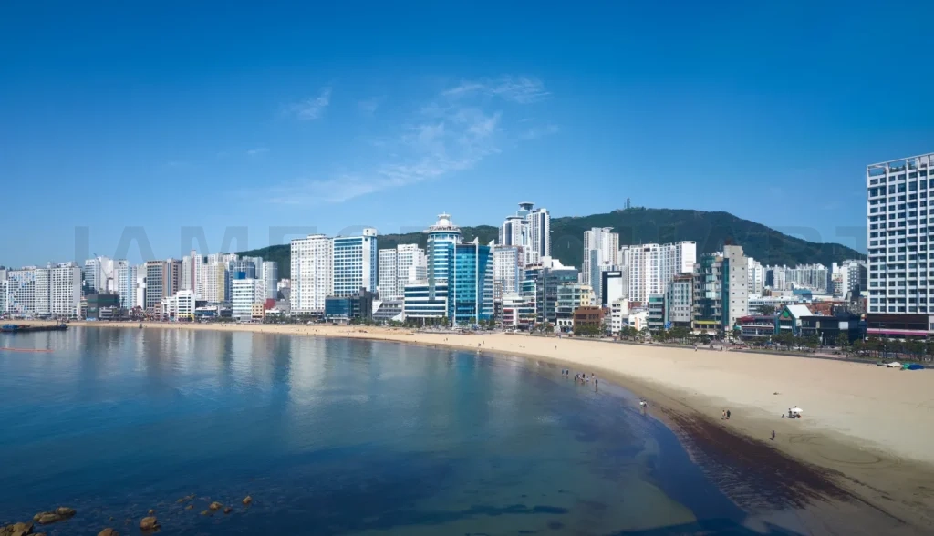 
Gwangalli Beach reflecting modern buildings under blue sky in bu