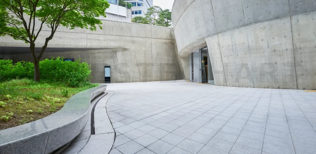
Empty modern building exterior with concrete facade and bench