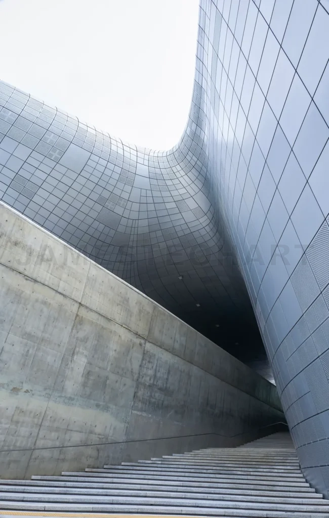 
Modern building exterior featuring concrete and metal facade