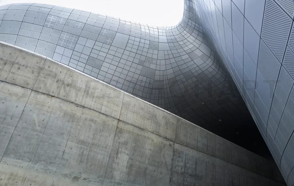 
Modern building exterior featuring concrete and metal facade