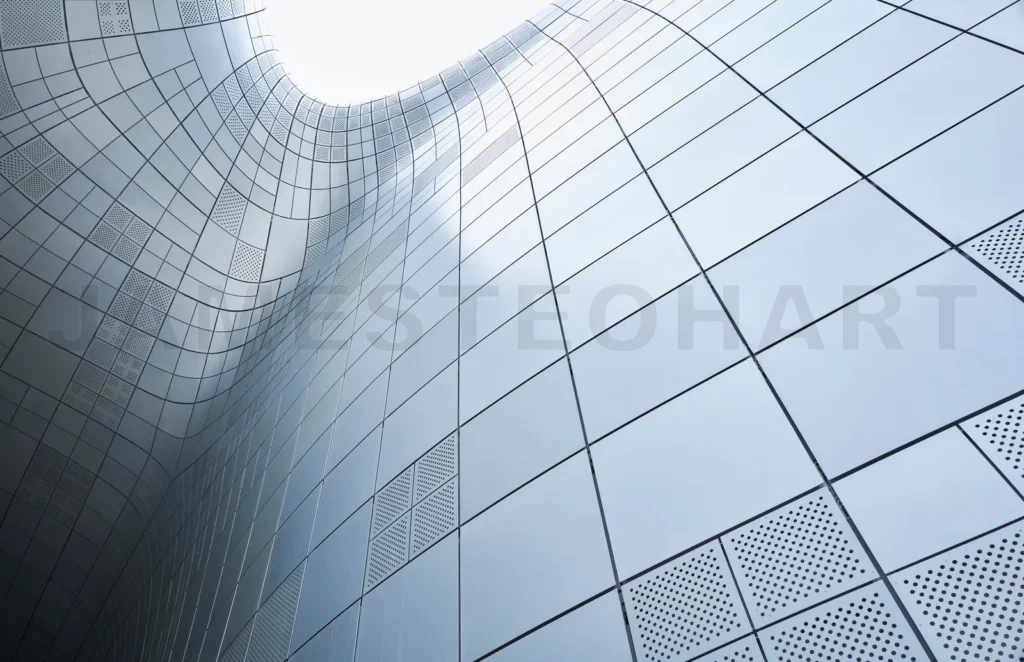 
Modern building exterior facade featuring metal panels forming curved shape