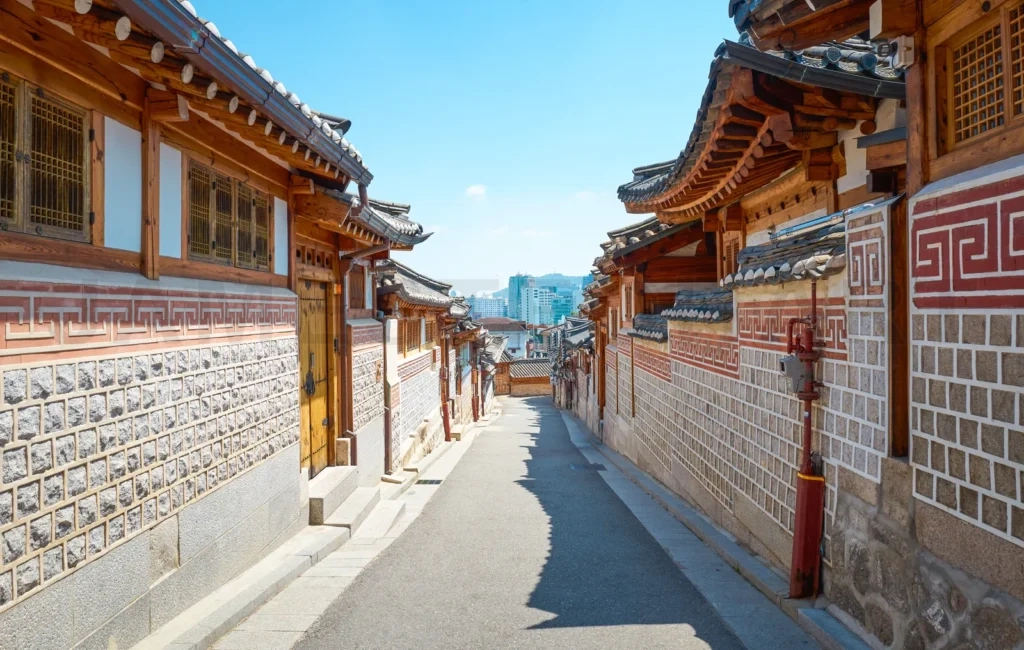 
Narrow street leading up a hill with traditional korean houses i