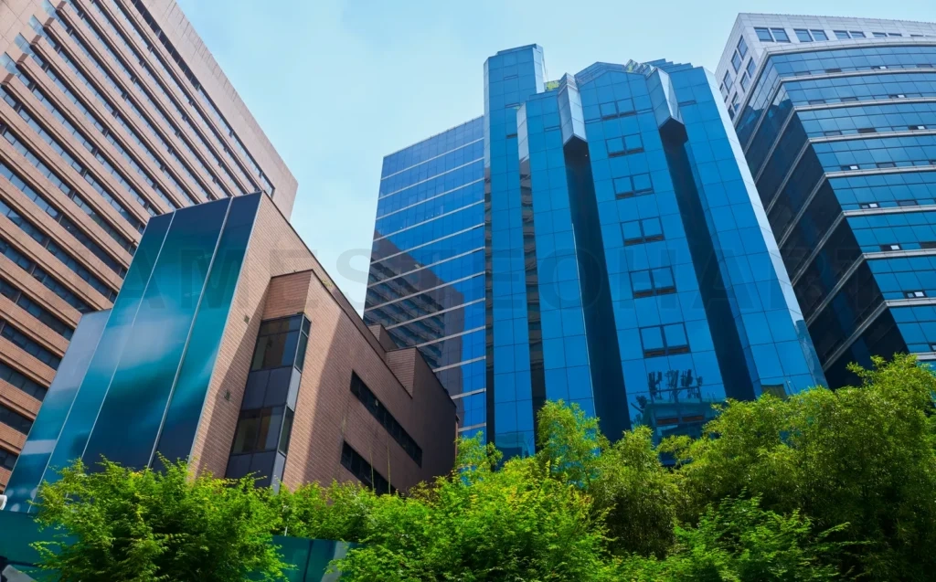 
Modern skyscrapers rising above green trees in urban city center