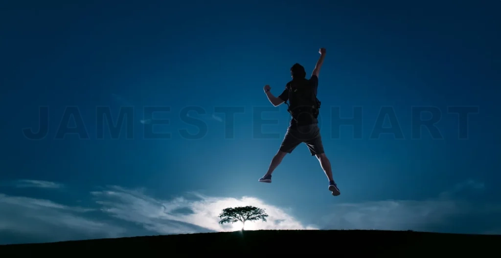
Silhouette image of young guy cheer and jump up with cold tone s