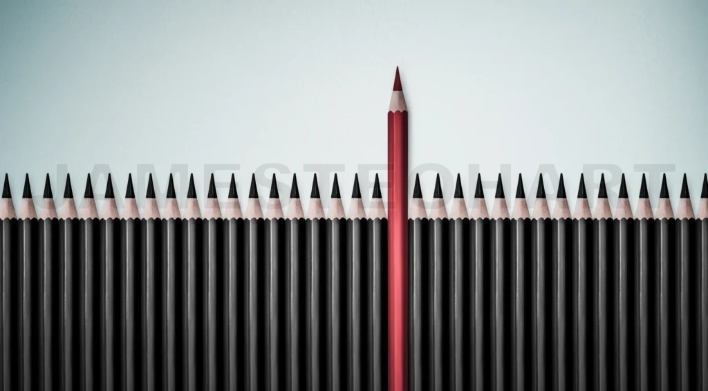 
Red Pencil Standing Out From Crowd Of Plenty Identical Black Fellows On White Table