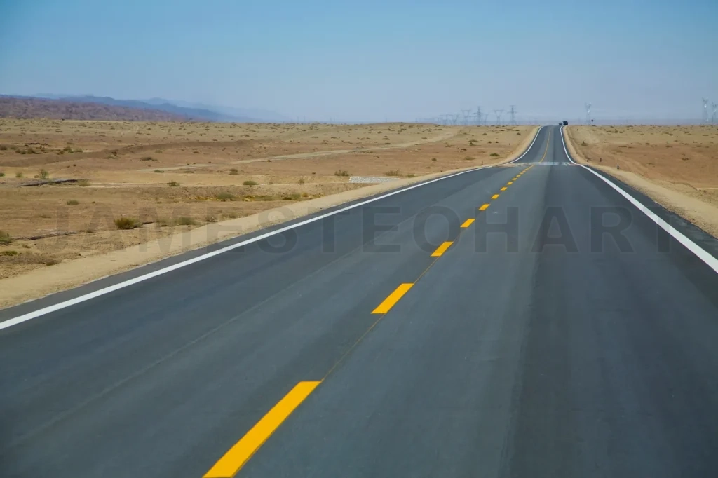 
Long Empty Asphalt Road In Desert With  Clear Blue Sky