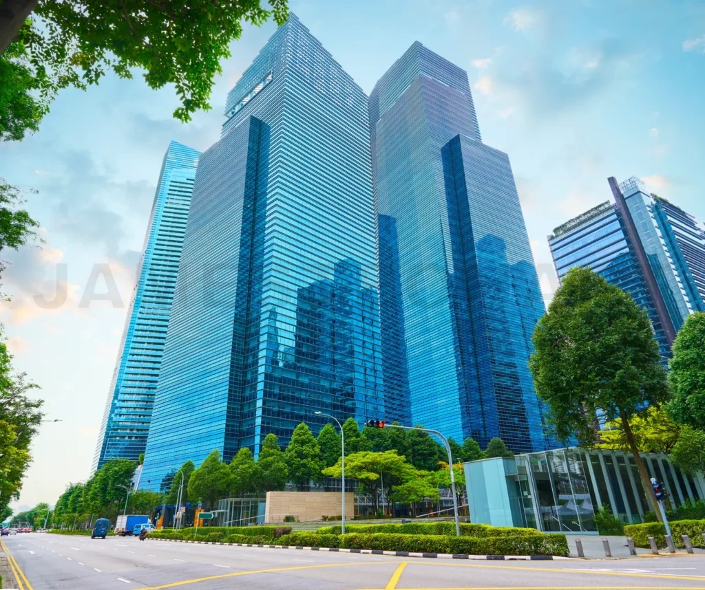 
Modern glass skyscrapers rising in urban business district with green trees
