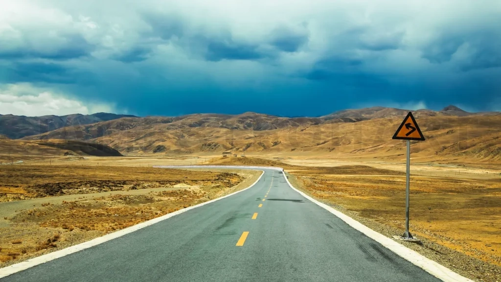 
Long Empty Asphalt Road In Desert With  Clear Cloudly Sky