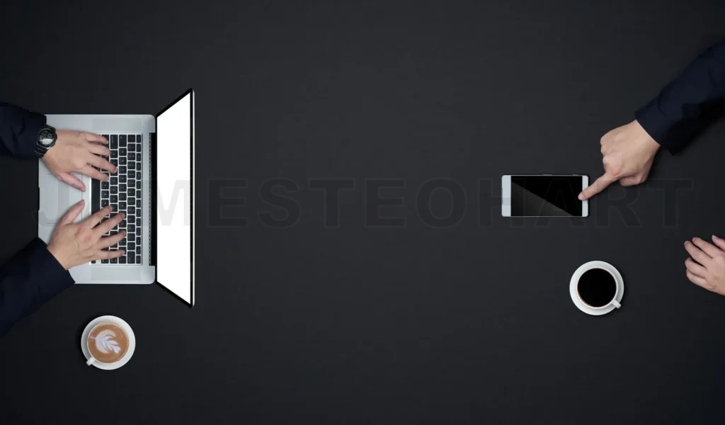 
Business professionals collaborating using laptop and smartphone technology