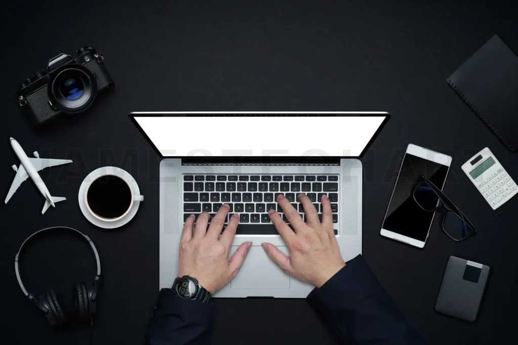 
Hands typing on laptop for business travel planning