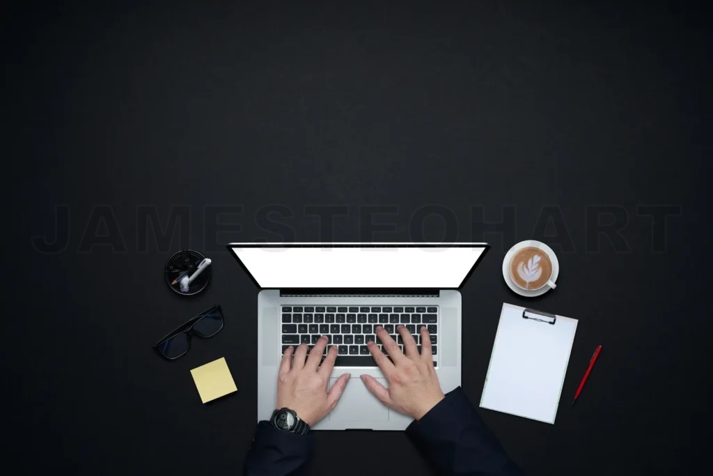 
Professional hands typing on laptop at dark desk