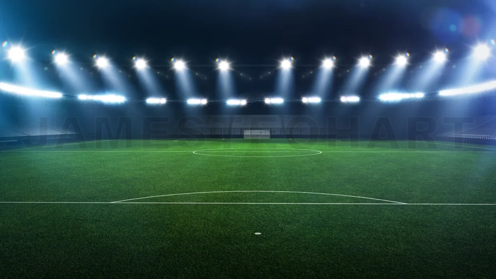 
Empty illuminated stadium football field at night
