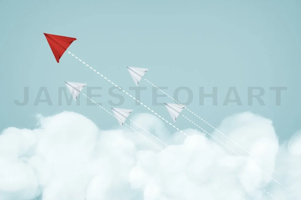 
Red paper plane leading white planes flying above clouds