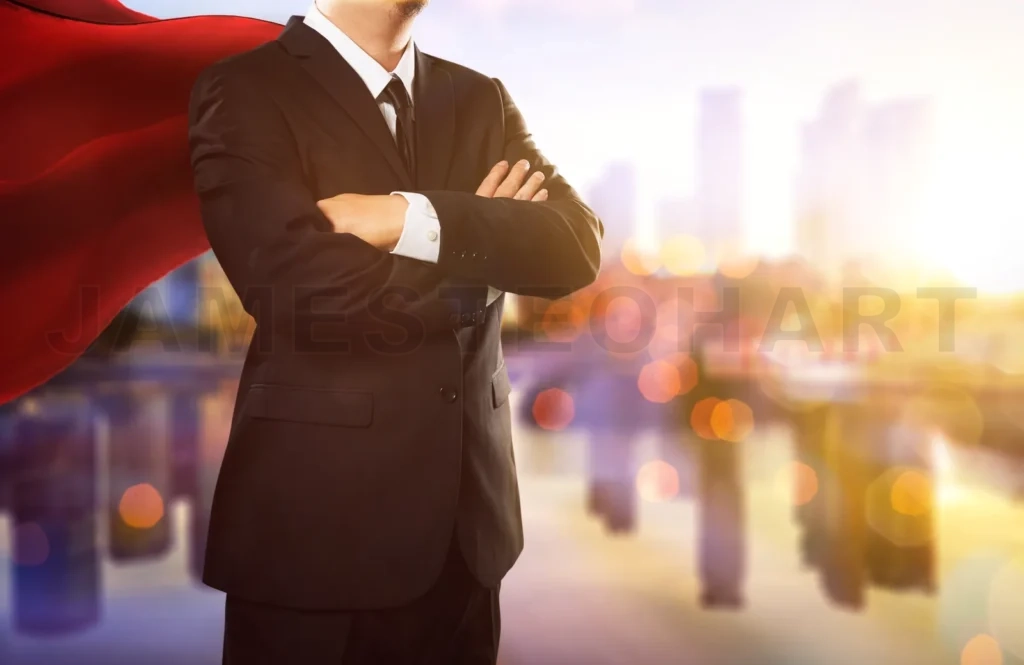 
Superhero Businessman Looking At City Skyline At Sunset