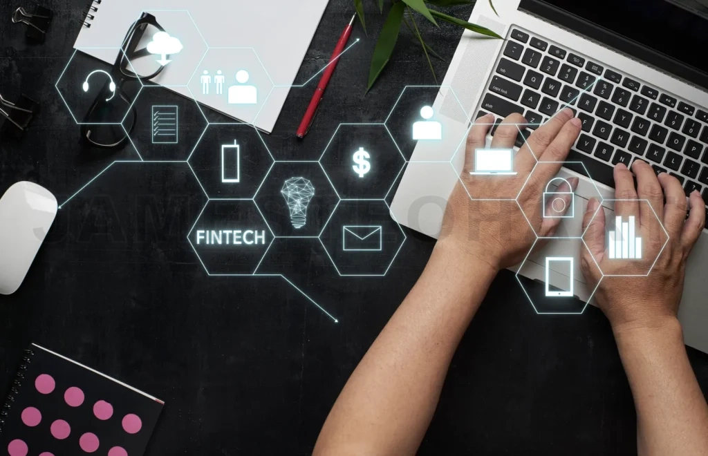 
“Fintech” Word On Digital Virtual Screen With Laptop, Male Hands, Notebook,Eyeglasses, Sketchbook, Black Wooden Desk Background