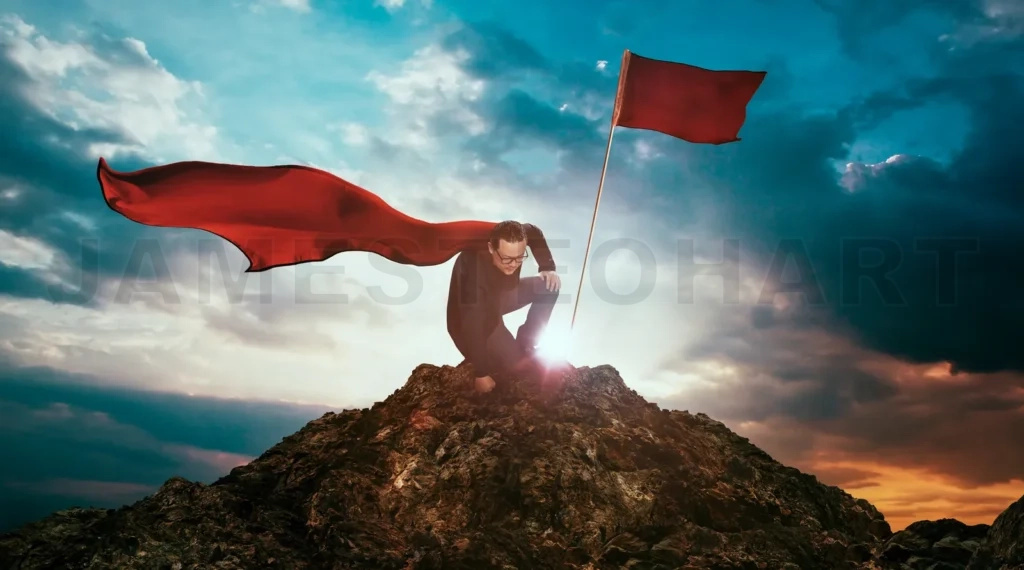 
Businessman In A Suit And Cape Hero On Top Of A Mountain,Business Success Concept