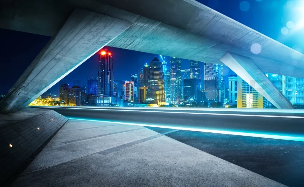 
Empty Asphalt Road Under The Bridge During The Night With Beautiful City Skyline Background